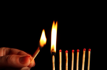 Burning matches on black background