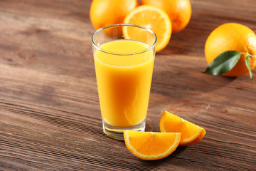 Orange juice on table on wooden background
