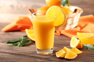 Orange juice on table on wooden background