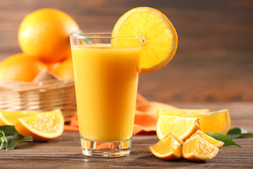 Orange juice on table on wooden background