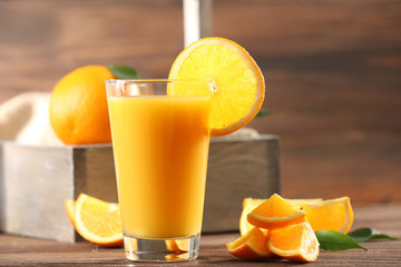 Orange juice on table on wooden background