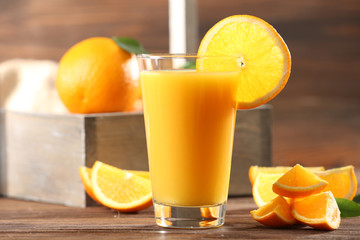 Orange juice on table on wooden background