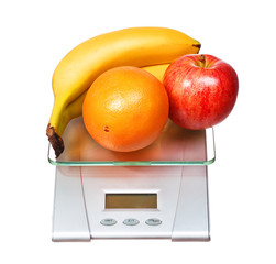 food scale with fruits apple banana and orange isolated on white background