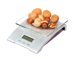 food scale with nuts isolated on white background