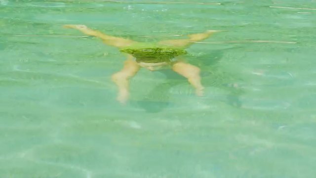 Woman emerges from water in a pool