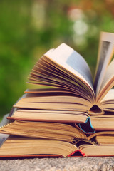 Stack of books outdoors, on blurred background