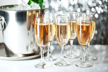 Glasses of champagne on bright background