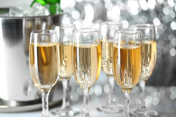 Glasses of champagne on bright background