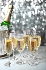 Glasses of champagne on bright background