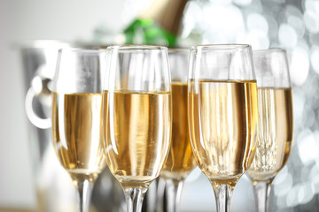 Glasses of champagne on bright background