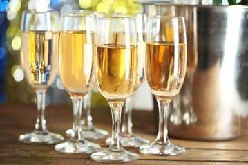 Glasses of champagne on bright background