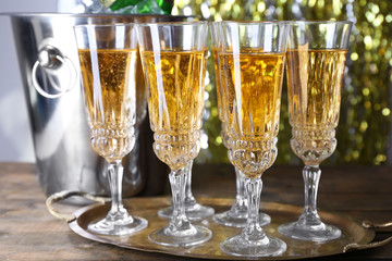 Glasses of champagne on bright background