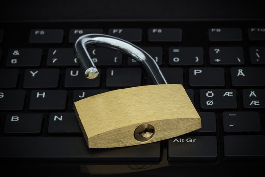 Close-up Of A Unlocked Padlock On A Computer Keyboard. Concept Photo Of Technology, Internet And Computer Security.