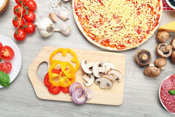 Food ingredients for pizza on table close up
