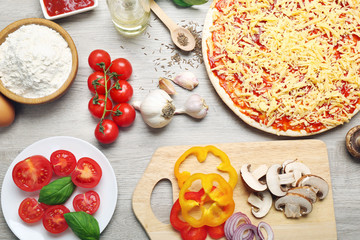 Food ingredients for pizza on table close up