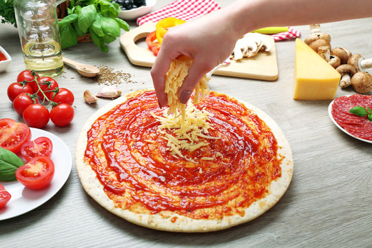 Woman Making Pizza On Table Close Up