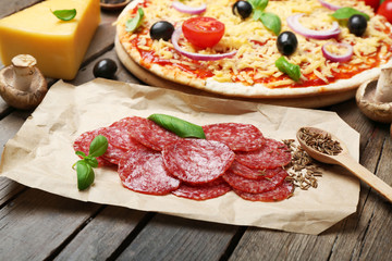 Food ingredients for pizza on table close up