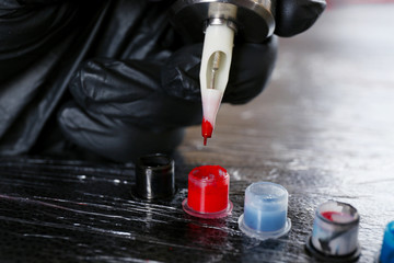 Tattoo artist at work close up