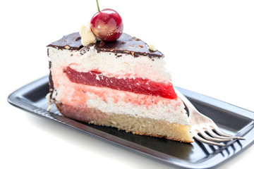 Piece of chocolate cake with cherry and vanilla.