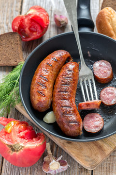 Frying pan with fried sausage.