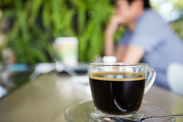 cup of coffee with man use laptop background