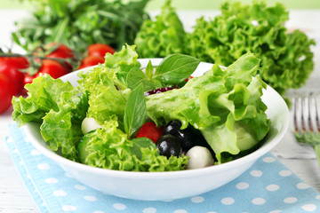 fresh vegetable salad in bowl on table close up