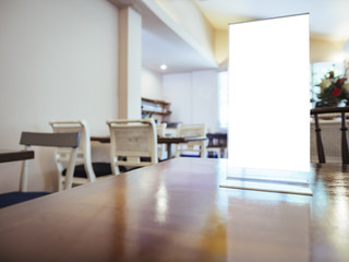 Mock up Menu frame on Table in restaurant cafe Background