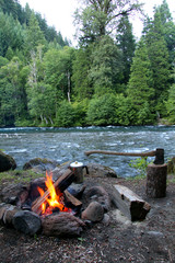 campfire with an axe river and coffee pot