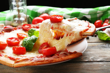 Delicious pizza with cheese and cherry tomatoes on wooden table, closeup