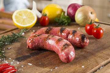 grilled meat sausages with potatoes and tomatoes