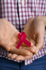 Female hands with color ribbon, closeup