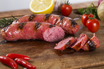 grilled meat sausages with potatoes and tomatoes