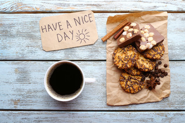 Cup of coffee with fresh croissant and Have A Nice Day massage on wooden table, top view