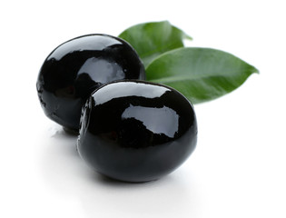 Black olives with leaves isolated on white