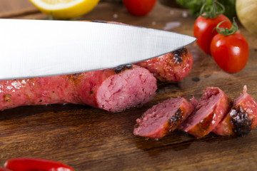 grilled meat sausages with potatoes and tomatoes