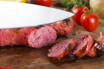 grilled meat sausages with potatoes and tomatoes