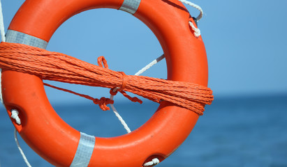 Orange jackets with rope to rescue swimmers in the sea in summer