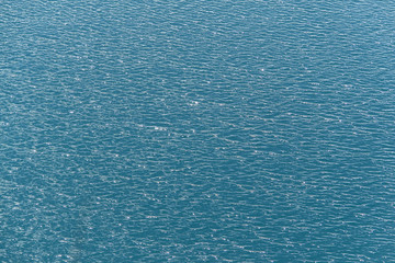 Intense blue sparkling water with ripples and waves