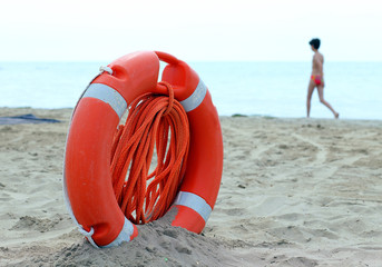 Orange jackets with rope to rescue swimmers in the sea in summer