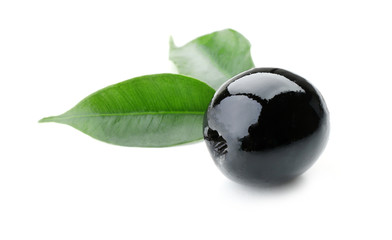 Black olive with green leaves isolated on white