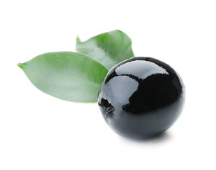 Black olive with green leaves isolated on white