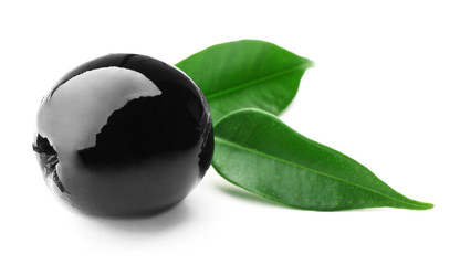 Black olive with green leaves isolated on white