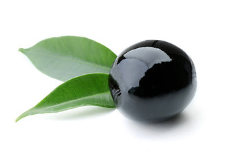 Black olive with green leaves isolated on white