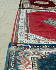 ancient carpets on sandy beach in Egypt