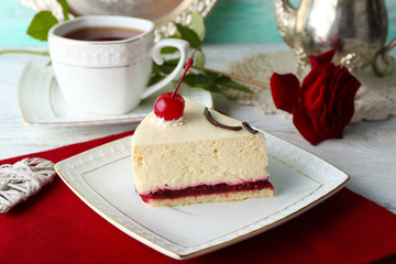 Tasty piece of cheesecake on plate on table close up