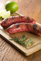 grilled meat sausages with potatoes and tomatoes