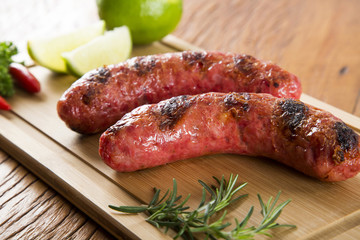 grilled meat sausages with potatoes and tomatoes