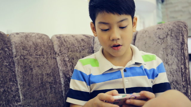 Asian child using a digital cell phone vintage style