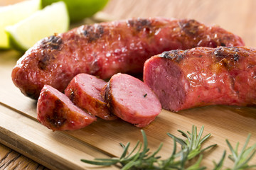 grilled meat sausages with potatoes and tomatoes