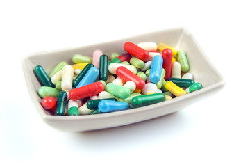 Lots of colorful pills on white background